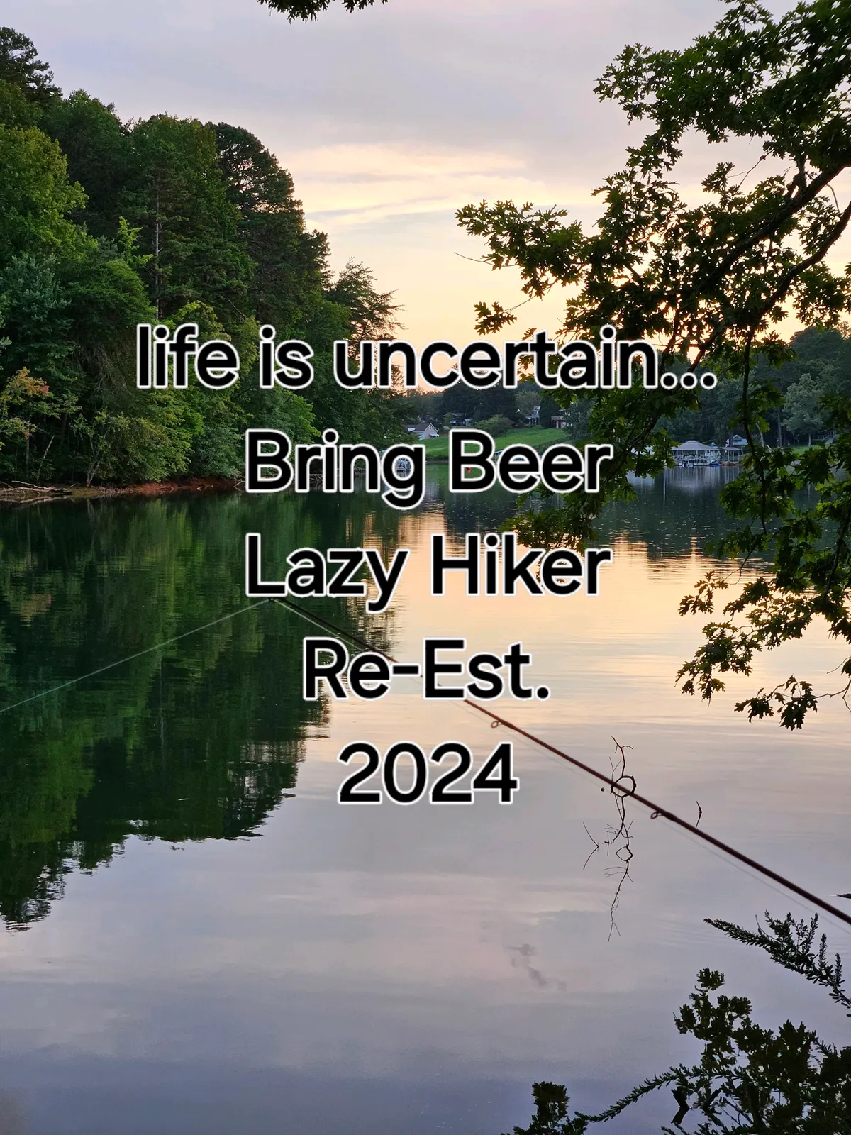 This image captures the serene surface of a nearby body of water reflecting surrounding trees and sky, suggesting an inviting, peaceful outdoor environment. The presence of a lighthearted text overlay adds a touch of local personality and humor.